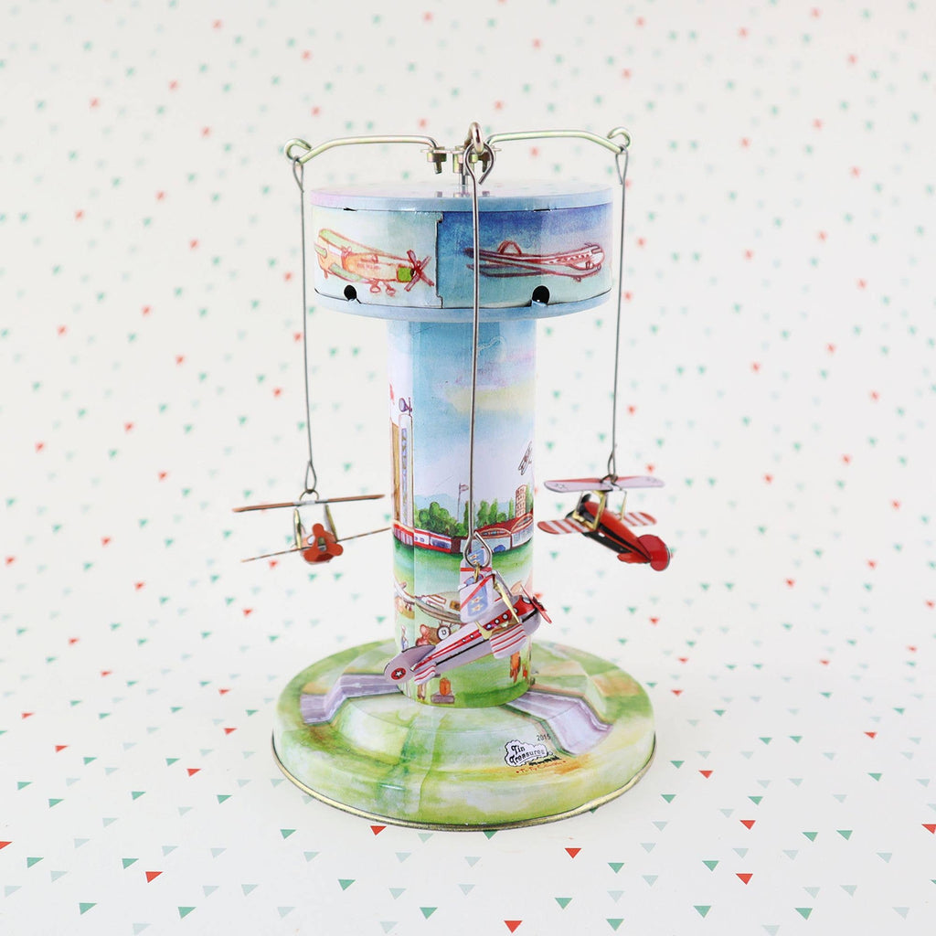 Vintage Blechspielzeug Karussell mit Flugzeugen handbemalt mechanisch 3 Flugzeuge auf buntem Hintergrund